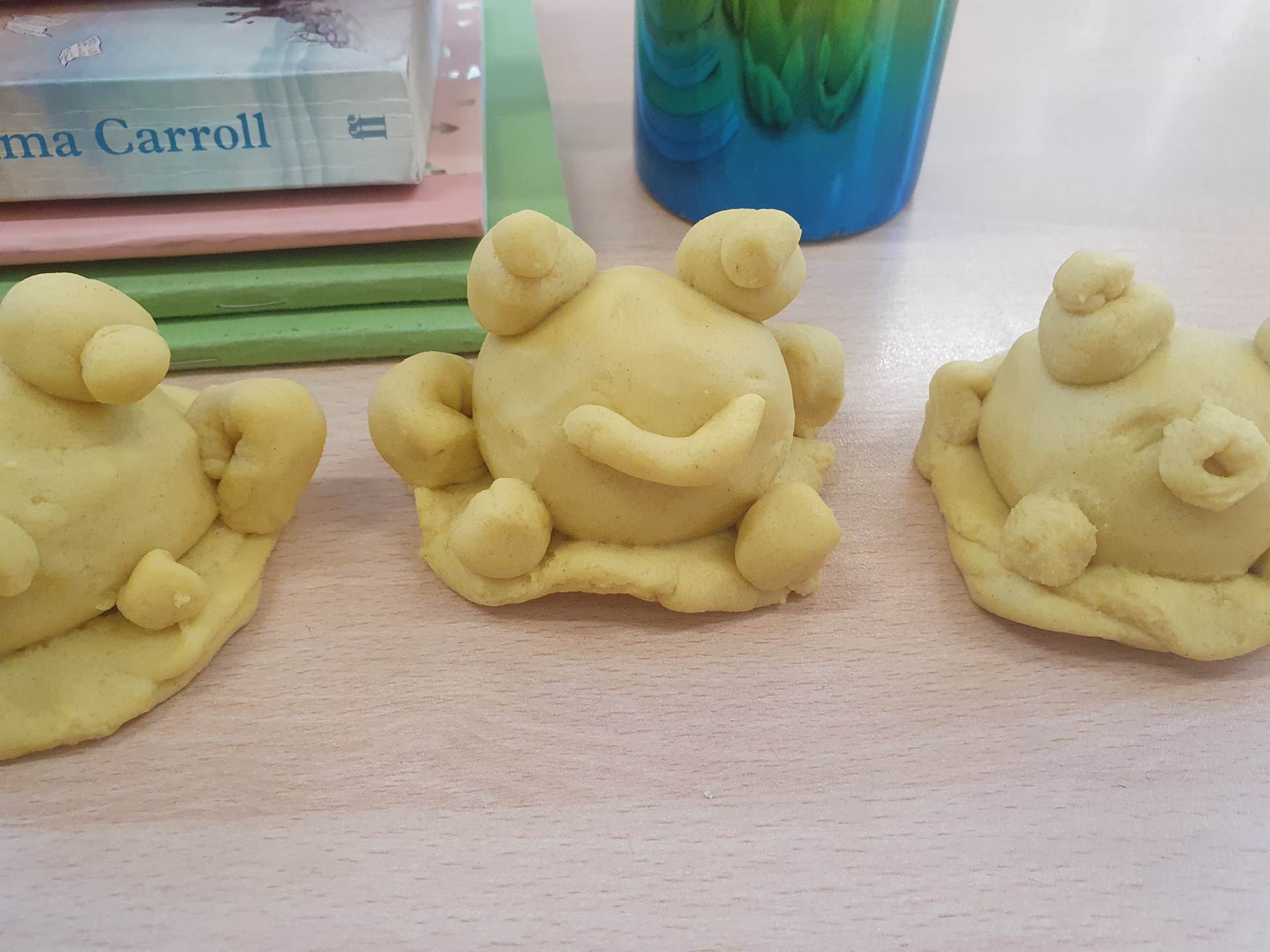 Making frogs from our own homemade playdough to illustrate a page from the book
